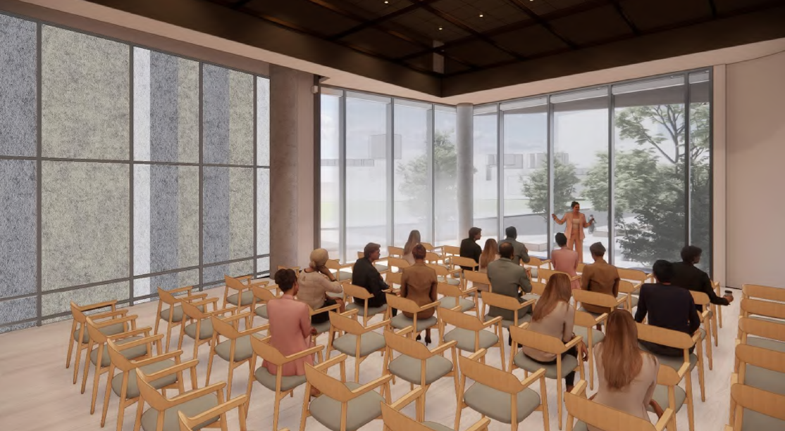 Animated image of the black box theatre, with people sitting on chairs and an individual presenting at the front of the room.