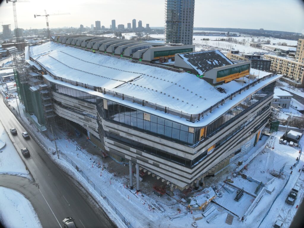 Exterior photograph of the building showcasing the windows and the side of the building, with some scaffolding in the background.