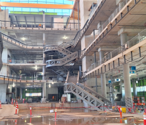 : Intérieur de l’édifice montrant l’escalier principal et l’ossature en acier achevée.